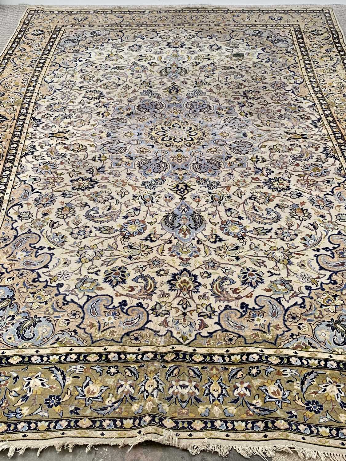 LARGE EASTERN STYLE RUG - multiple bordered with tasselled ends, mainly beige and blue ground with