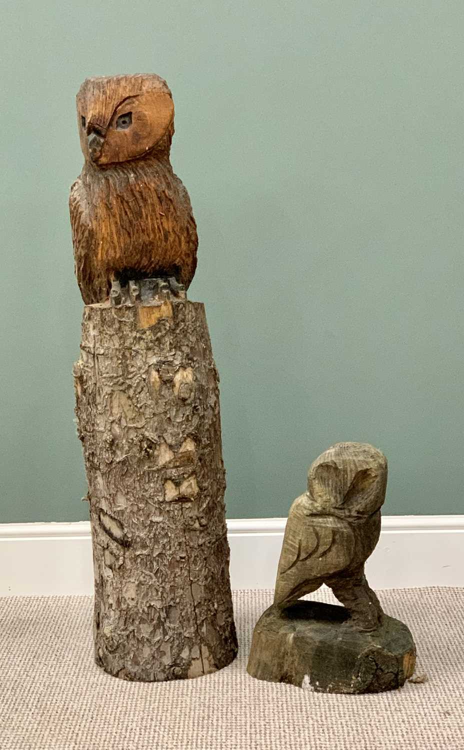 TWO CARVED WOODEN OWL GARDEN ORNAMENTS - one seated on a natural trunk, 110cms H, the other fully