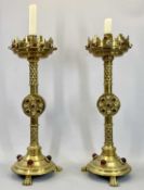 VICTORIAN GOTHIC REVIVAL BRASS ALTAR CANDLESTICKS, A PAIR - set with coloured cabochon stones, the