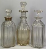 TWO SILVER COLLARED GLASS DECANTERS & ONE OTHER - the tallest having a collar to the upper rim