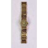 LADY'S 9CT GOLD INTEGRAL BRACELET WRISTWATCH - having an oval black dial, dot markers and Roman