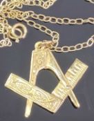 9CT GOLD SECRET MASONIC SQUARE & COMPASSES PENDANT on an unmarked yellow metal necklace, 2.5cms