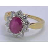 18CT GOLD PINK RUBY & DIAMOND CLUSTER RING - in excess of 1ct facet cut oval central stone, 8 x 6mm,