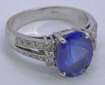 18CT WHITE OVER YELLOW GOLD BLUE TANZANITE & DIAMOND RING - 2.78ct central stone, 11 x 8mm, facet