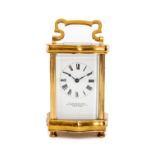 FRENCH GILT BRASS CARRIAGE CLOCK, in serpentine shaped case, five bevelled glass panes, Roman