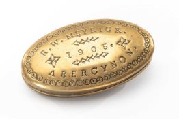 AN EDWARDIAN BRASS SNUFF BOX, of oval form, engraved 'R.W Meyrick, Abercynon, 1905', 8cm wide