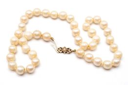 CULTURED PEARL SINGLE STRAND CHOKER, of 8mm pearls to a 9ct gold and seed pearl-set double bow