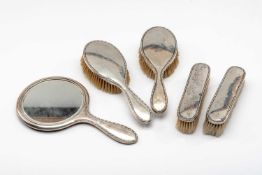 GEORGE V SILVER VANITY SET comprising mirror and four brushes, Sheffield 1921, Walker & Hall (5)