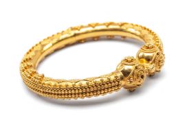 INDIAN YELLOW GOLD HINGED BANGLE with overall applied geometric ball decoration, stamped ‘22ct KDM
