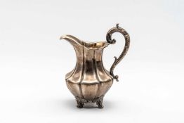 VICTORIAN SILVER CREAM JUG, scroll handle and four scroll feet, engraved to base 'Presented to