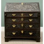 OAK BUREAU - late 19th Century, heavily carved detail of thistles to the forefront over four long