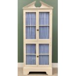 TALL PAINTED CUPBOARD - with broken architectural pediment over four fabric backed glazed doors,