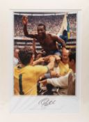 A COLOURED PHOTOGRAPHIC PRINT image of Pelé being lifted onto his teammate's shoulders celebrating