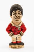 GROGG CARICATURE BY JOHN HUGHES OF AND AUTOGRAPHED BY BARRY JOHN standing on titled base, 'Grandslam