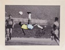 A BLACK & WHITE PHOTOGRAPHIC PRINT of Pelé playing for Brazil, the print being colour enhanced in