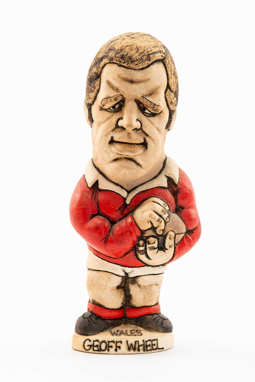 GROGG CARICATURE BY JOHN HUGHES OF GEOFF WHEEL standing on titled base, 'Wales Grand Slam 1976 and