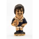 GROGG CARICATURE BY JOHN HUGHES OF ANDY IRVINE standing on titled base, wearing his Scotland No.15