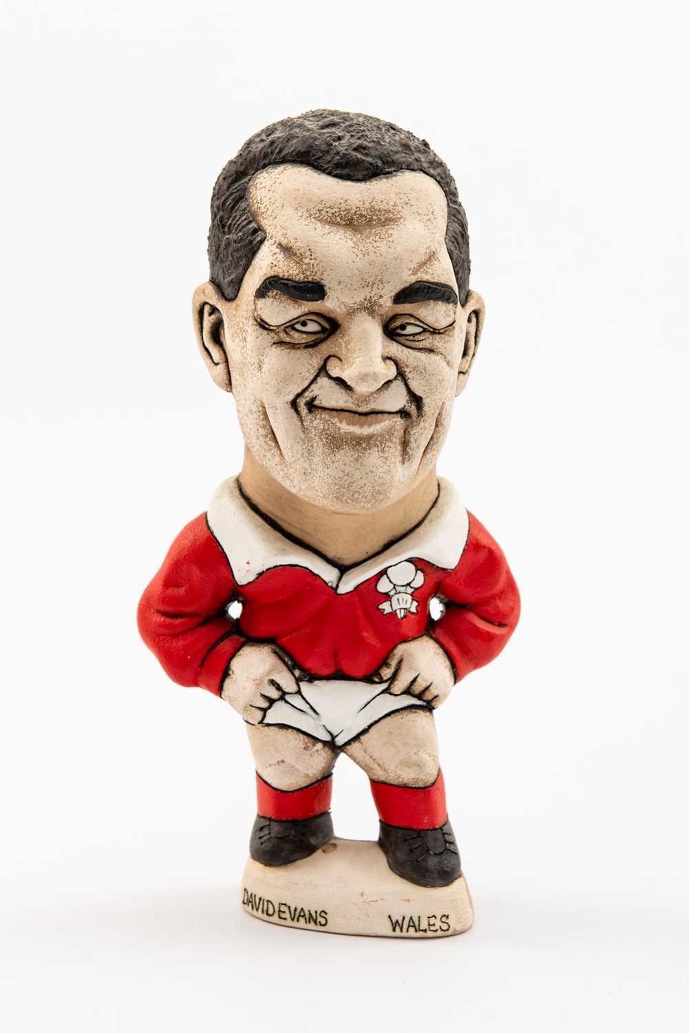 GROGG CARICATURE BY JOHN HUGHES OF DAVID EVANS standing on titled base, wearing his Wales No.10 kit,