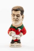 GROGG CARICATURE OF MIKE RAYER (Grogg Shop Wales) standing on titled base, wearing his Wales No.15