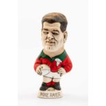 GROGG CARICATURE OF MIKE RAYER (Grogg Shop Wales) standing on titled base, wearing his Wales No.15