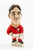 GROGG CARICATURE OF RUPERT MOON (Grogg Shop Wales) standing on titled base, wearing his Wales No.9