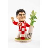 GROGG POTTERY CARICATURE OF ENTERTAINER MAX BOYCE standing in red jacket, with Wales rosette,