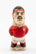 GROGG CARICATURE OF PHIL DAVIES (Grogg Shop Wales) standing on titled base, wearing his Wales No.4