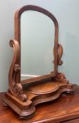 VICTORIAN WALNUT DRESSING MIRROR, arched plate between scrolled uprights, on serpentine base with