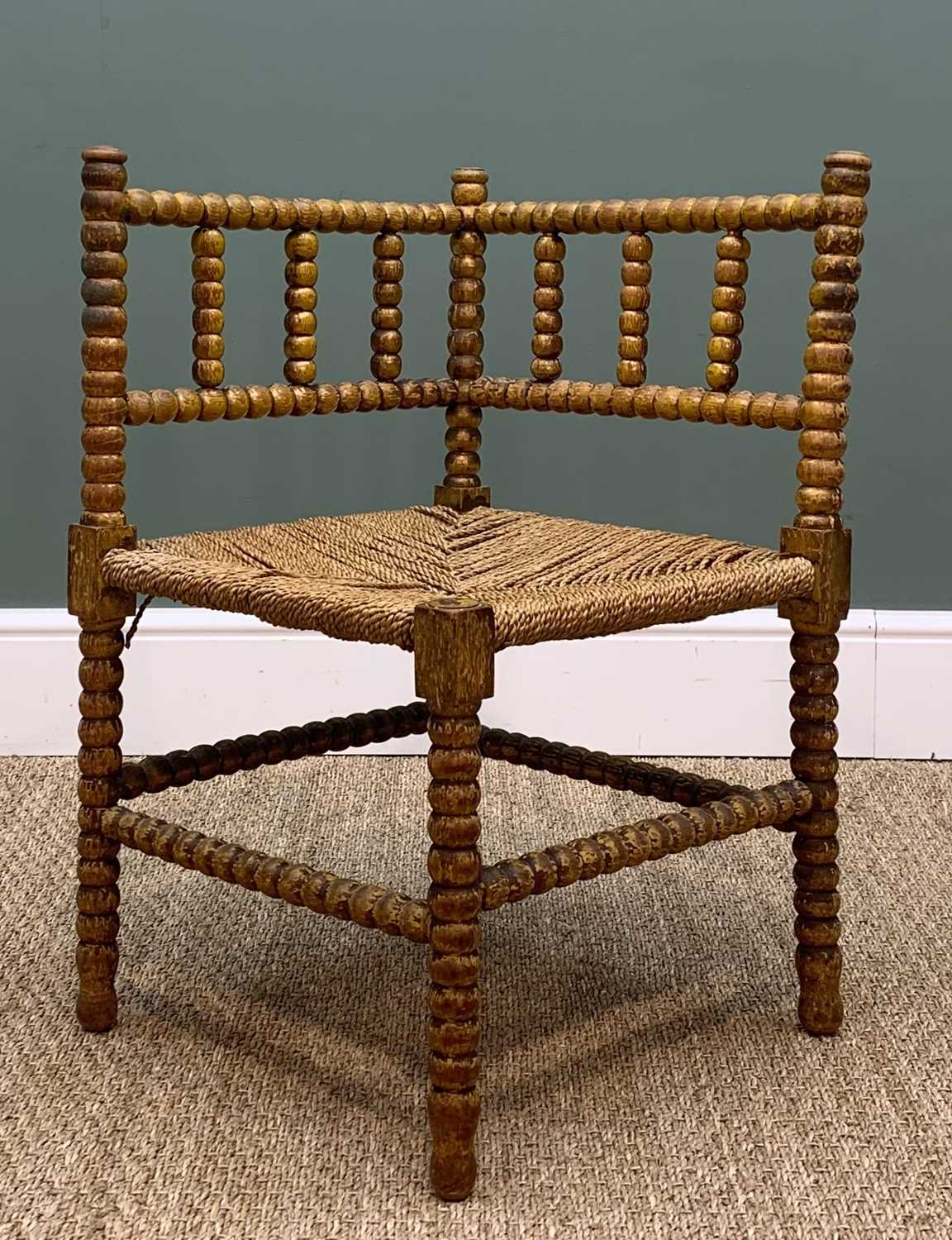 VINTAGE BOBBIN TURNED PAINTED CORNER CHAIR, rush seat, 66cms high Provenance: private collection