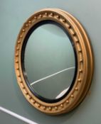 REGENCY STYLE CONVEX MIRROR, with reeded ebonised slip, 80cms diameter Comments: re-painted, slip