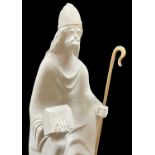 CARVED LIMESTONE SCULPTURE OF SAINT DYFRIG, 20th Century, holding a casket and wooden crozier 50cm