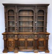SUBSTANTIAL FLEMISH CARVED OAK BOOKCASE, in the Renaiassance style, with foliate and lunette