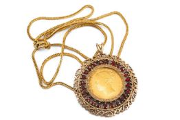 1871 VICTORIA SOVEREIGN GOLD PENDANT, young head, in 9ct gold and garnet set frame, with chain,