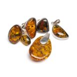 SILVER SET AMBER JEWELLERY comprising three rings, two pendants and a pair of earrings (7)