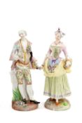 TWO LARGE DRESDEN PORCELAIN FIGURES, of a lady and gallant, she with basket and apron full of