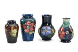 FOUR MOORCROFT POTTERY VASES, 'Anemone' pattern, comprising baluster vase, 12.5cms high, pear shaped
