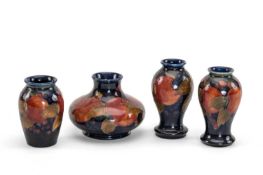 FOUR MOORCROFT POTTERY VASES, 'Pomegranate' pattern, comprising squat vase, shouldered vase and pair