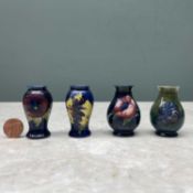 FOUR MINIATURE MOORCROFT POTTERY VASES, in 'Pansy', 'Anemone', and 'Hibiscus' patterns, all about