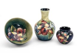 THREE MOORCROFT POTTERY ITEMS, 'Iris' pattern, comprising pedestal bowl, squat jar, and pear