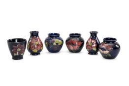 SIX MOORCROFT POTTERY ITEMS, 'Anemone' pattern, comprising three globular jars, two pear shaped