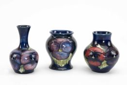 THREE MOORCROFT POTTERY VASES, 'Pansy' pattern, comprising bottle vase, squat vase and baluster
