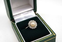 WHITE METAL PEARL & DIAMOND HALO RING, the central pearl surrounded by twelve diamonds totalling 0.