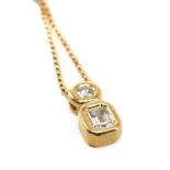 DIAMOND & 18CT GOLD PENDANT, set with emerald-cut diamond 6mm x 4mm, and brilliant-cut diamond 4mm