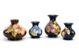 FOUR MOORCROFT POTTERY VASES, 'Hibiscus' pattern, comprising three pear shaped vases and a squat
