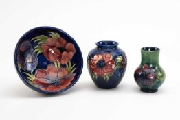 THREE MOORCROFT POTTERY ITEMS, 'Anemone' pattern, comprising a footed bowl, 16cms diameter, ovoid