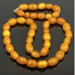 BUTTERSCOTCH AMBER BEAD NECKLACE & SIMILAR OVAL BEAD BRACELET - 69.1grms gross, 29 near uniform