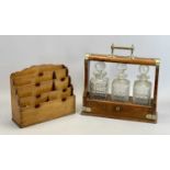 EDWARDIAN OAK 3 BOTTLE TANTALUS - with EPNS mounts, containing three square cut glass decanters with