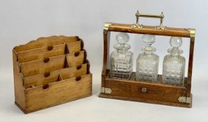 EDWARDIAN OAK 3 BOTTLE TANTALUS - with EPNS mounts, containing three square cut glass decanters with