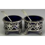VICTORIAN SILVER TABLE SALTS, A PAIR - along with two non-matching spoons, Sheffield 1845, Henry