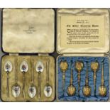 SILVER & ENAMEL/SILVER GILT TEASPOONS/TWO CASED SETS OF SIX - the enamelled set decorated to the